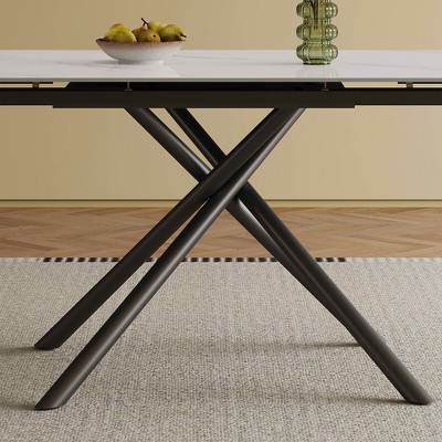 Close-up of the table base: black metal legs forming an X-cross design