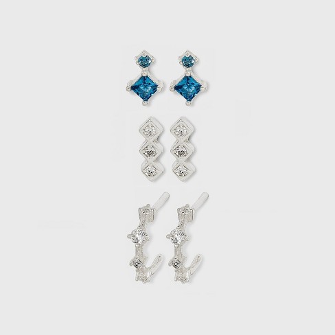 Long silver earrings with a coral pattern and a blue cubic zirconia