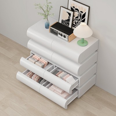 Open drawer dresser showing inside organization and folded textiles