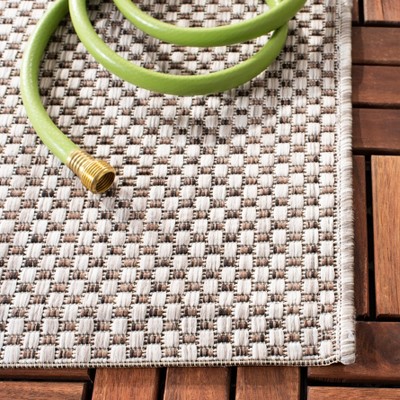 Beige and Brown 27'' Non-Slip Synthetic Courtyard Rug