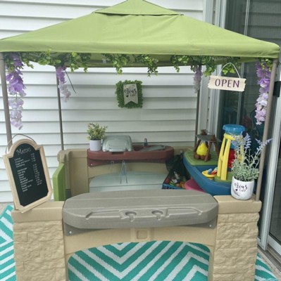 All around playtime patio with store canopy playhouse