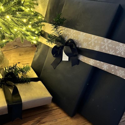 Elegant black Christmas theme. Wrapped gifts in black matte paper
