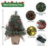 Mini artificial Christmas tree with lights, featuring a burlap base Compact holiday tree adorned with pinecones and clusters of red berries - 3 of 4