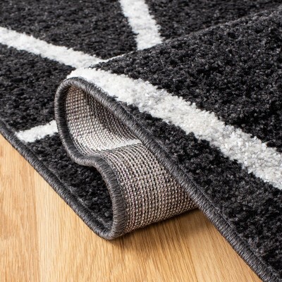 Black and Ivory Geometric Synthetic Area Rug