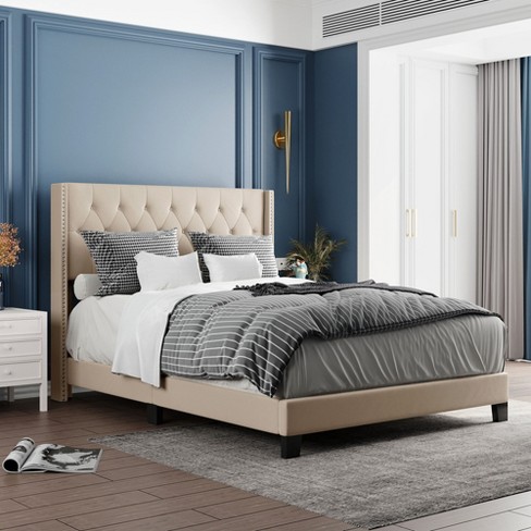 Beige upholstered store bed full