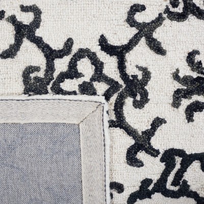 Handmade Black and Ivory Wool Floral 8' x 10' Rug
