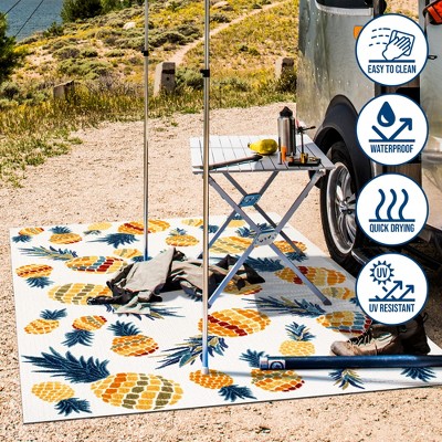 4' x 6' Ivory and Orange Floral Synthetic Area Rug