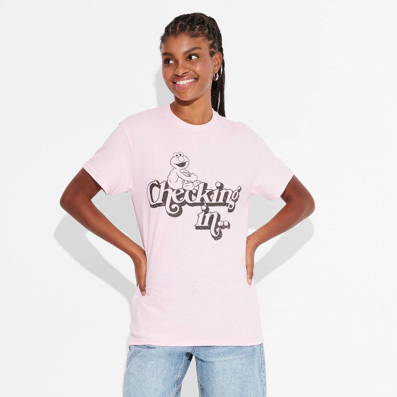 Women's Elmo Checking in... Short Sleeve Graphic T-Shirt - Light Pink, 1 of 4