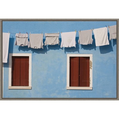 23" x 16" Hanging Laundry Along Wall by Brenda Tharp Danita Delimont Framed Canvas Wall Art Blue - Amanti Art