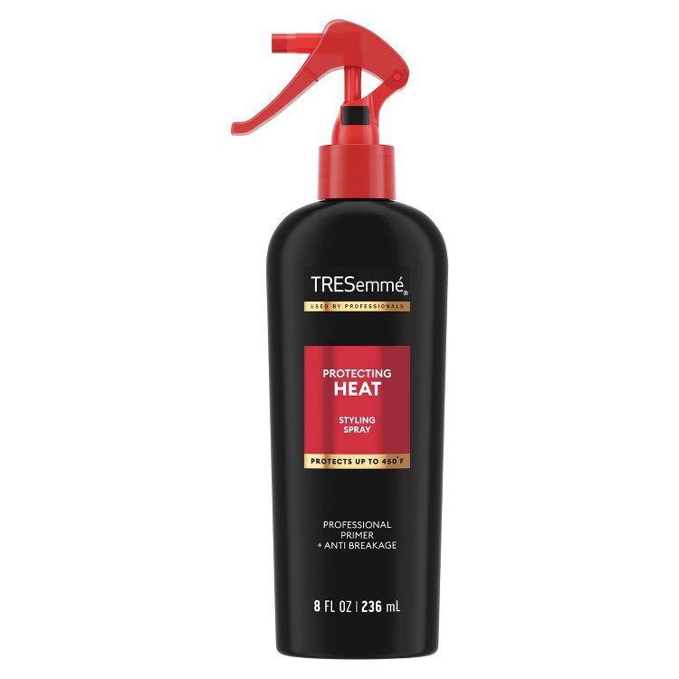 Black bottle of TRESemmé Protecting Heat Styling Spray with a red trigger nozzle, labeled "Protects up to 450°F" and "8 FL OZ | 236 mL."