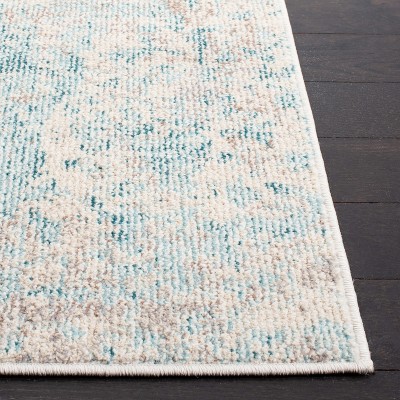 Ivory and Teal 4' x 6' Synthetic Non-Slip Rectangular Rug