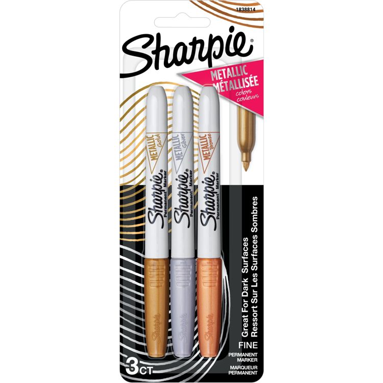 Three metallic colored Sharpie markers in gold, silver, and bronze with fine tips, packaged in a blister pack labeled "Great For Dark Surfaces."