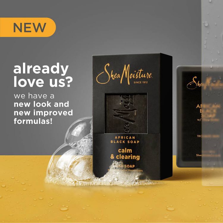 SheaMoisture African Black Soap Calm & Clearing Bar Soap. The updated packaging features a sleek black box with gold text. The background has a soft gray gradient with bubbles, highlighting the soap's refreshing and cleansing qualities. 