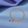 Free bird Cross Birthstone Bracelet | Dainty 14K Gold Plated Cross Charm Bracelet | Stretchable Elastic Gold Beaded Bracelet - 4 of 4