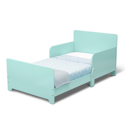 Mint green toddler bed shown from a diagonal angle