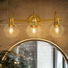 DORESshop 20 in. 3-Light Matte Black and Gold/Gold Industrial 3-Light Bathroom Vanity Light with Clear Glass Globe Shades Bathroom - 3 of 4