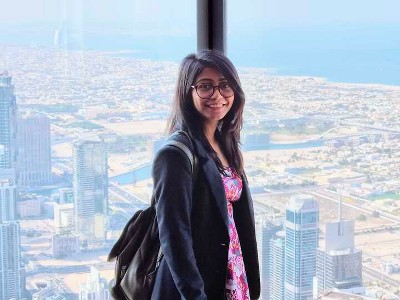 Headshot of Sohini Mitra, a woman with black hair and glasses, wearing a black blazer.