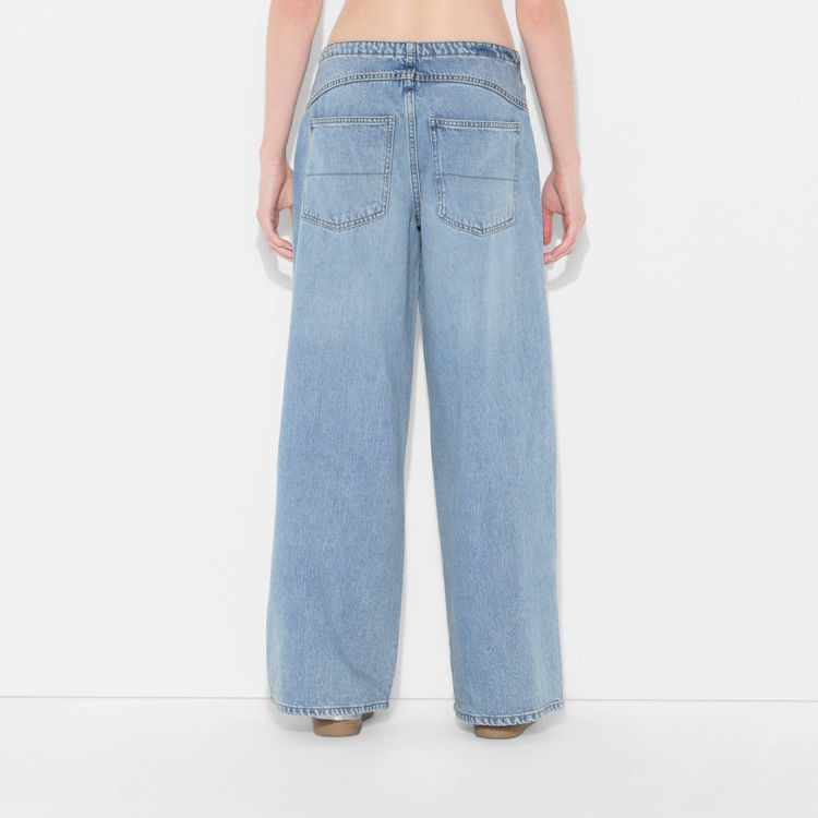 Light blue colored wide-leg jeans with back pockets, shown from the rear.