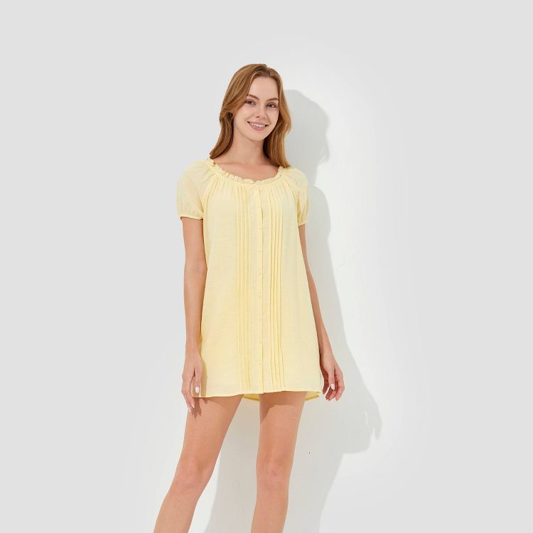 Light yellow colored short dress with a round neckline and short sleeves.