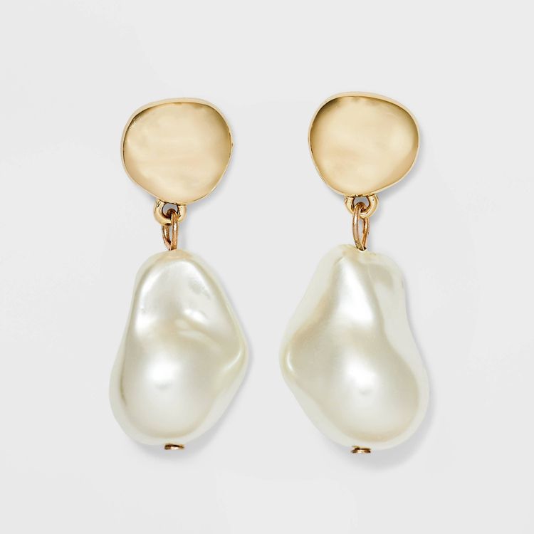 Gold colored earrings with irregular pearl-like drops.